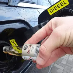 Ręka wlewa dodatek do paliwa benzyna do baku diesla.
