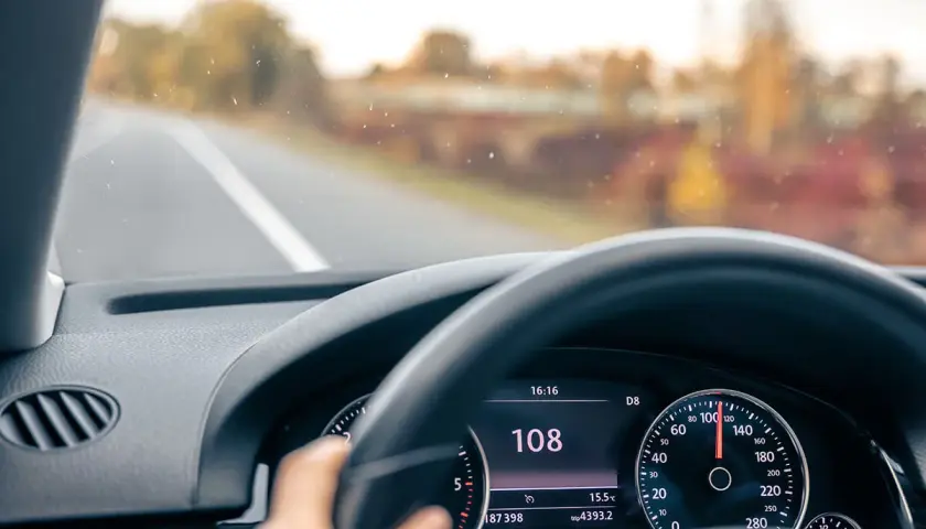 Prędkościomierz pokazuje 108 km/h. Uważaj, bo wysokie mandaty za prędkość czekają na nieostrożnych kierowców.