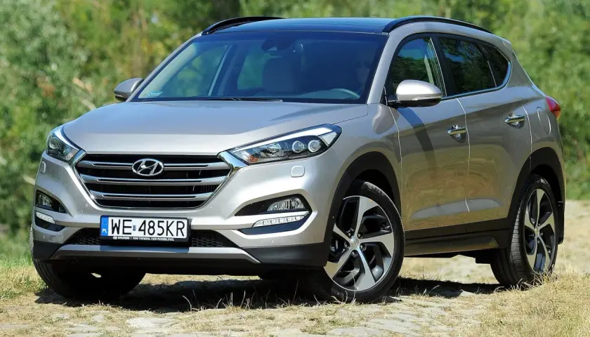Srebrny Hyundai Tucson 3 na tle zieleni.