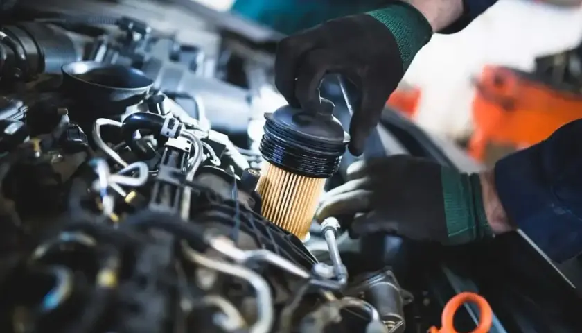 Mechanik wymienia filtr paliwa w silniku. Pamiętaj, co ile wymieniać filtr paliwa, by auto działało sprawnie.