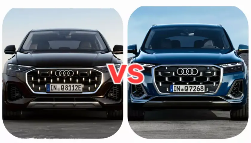 Dwa nowe Audi Q7 w zbliżeniu, czarne i granatowe, z napisem "VS" pośrodku.