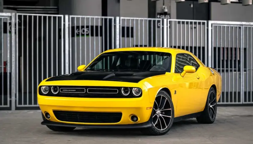 Żółty Dodge Challenger z czarną maską, idealny na letnie przejażdżki. Sprawdź jego atrakcyjną dodge challenger cena!