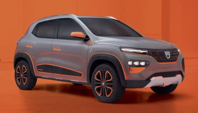 Szary Dacia Spring Electric z pomarańczowymi akcentami, prezentujący nowoczesny design miejskiego SUV-a.