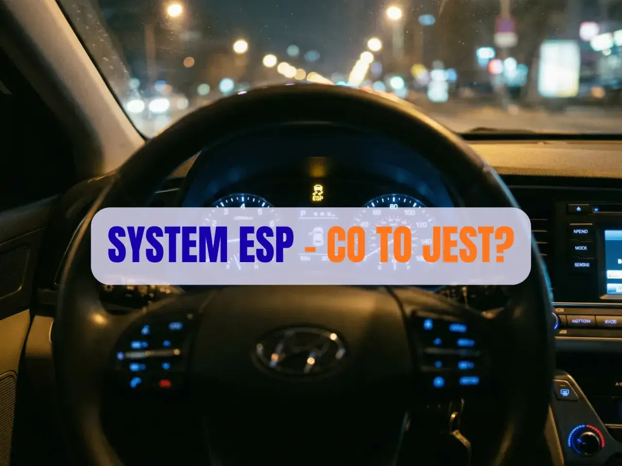 Widok na deskę rozdzielczą samochodu nocą. Na wyświetlaczu świeci się kontrolka ESP, a na kierownicy napis "SYSTEM ESP - CO TO JEST?".