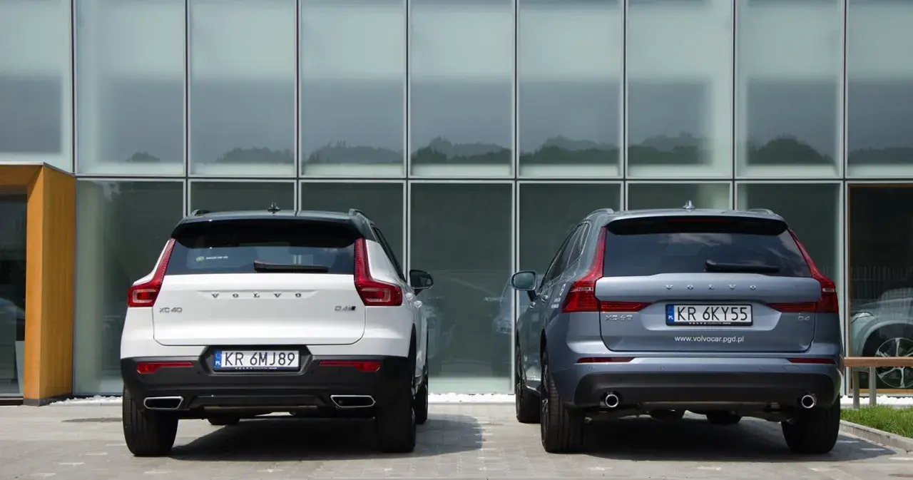 Dwa SUV-y Volvo: białe XC40 i szare XC60. Porównanie ich tyłu i rozmiarów.